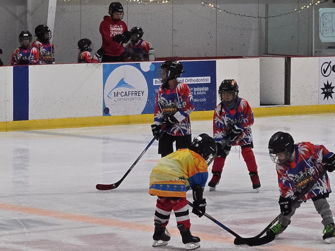 Young players on the ice in custom palm print jerseys