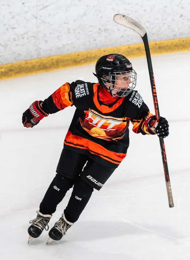 Young player celebrating in a custom orange and black jersey