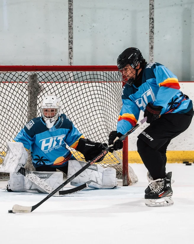 Goalie and shooter in custom sky blue camp jerseys